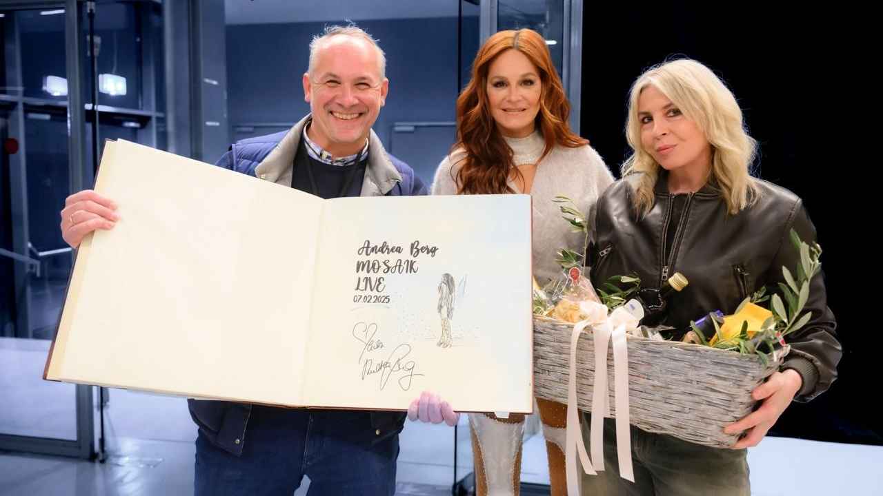 Bei der Geschenkübergabe (von links): Christof Strimitzer (Leitung Marketing und Kommunikation MCG), Andrea Berg und Sara Dalkouhi (Projektleitung MCG) mit dem Gästebuch der Stadthalle..