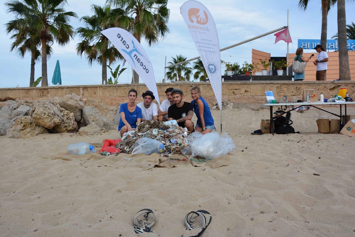 Mit Plastik unter Palmen am Strand von Mallorca: die drei Itchy-Musiker mit zwei OceanCare-Repräsentanten