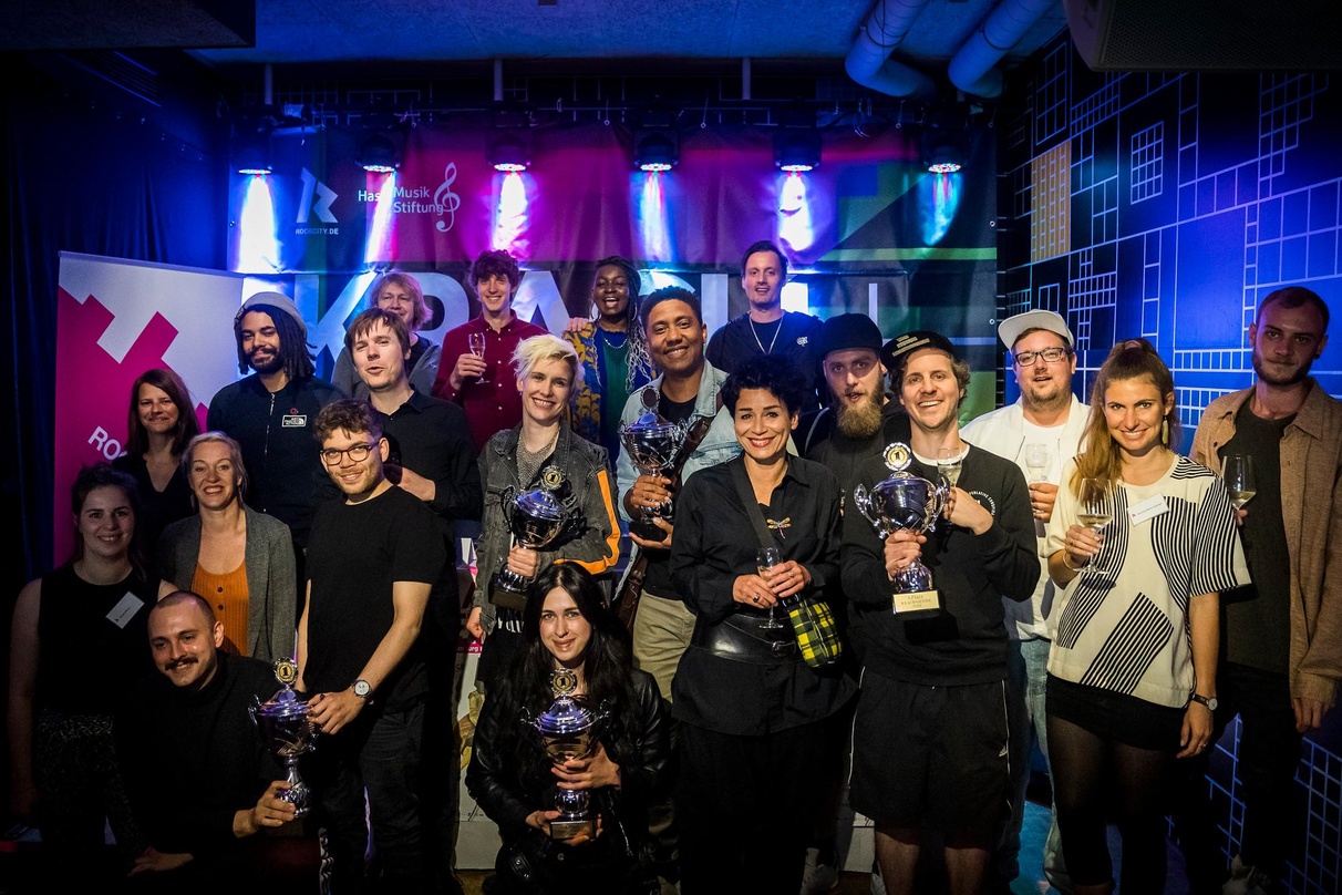 Bei der Preisverleihung 2019: die Gewinner von Krach + Getöse zusammen mit der Jury und Andrea Rothaug (Geschäftsführerin RockCity, 6. von rechts)