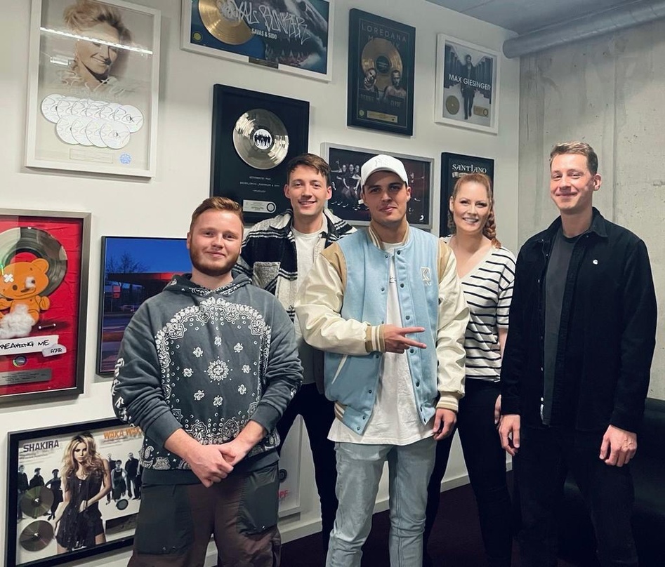 b850b2a8b832443f2f0e4917044d376fb1cbe997a6b278edd5bc2f84ca8551f0 Neue Partner (von links): Marvin Lutz (Junior Creative Manager SMP), Andre Midek (Management Robin Wick), Robin Wick, Alexandra Ziem (Director Creative SMP) und Sascha Wernicke (Management...